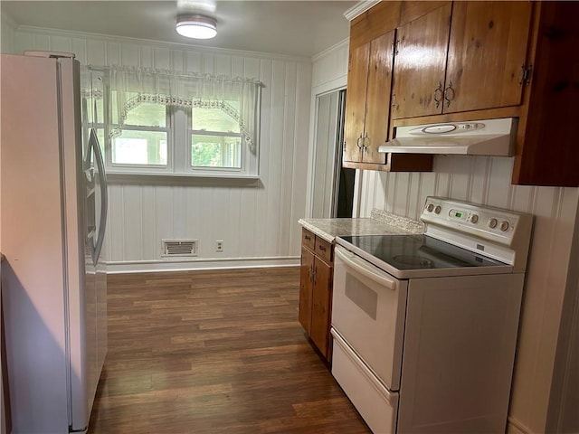 502 Cheyenne St, Anderson, SC 29626 - kitchen featuring white appliances, under cabinet range hood, dark wood-style flooring, baseboards, and brown cabinetry