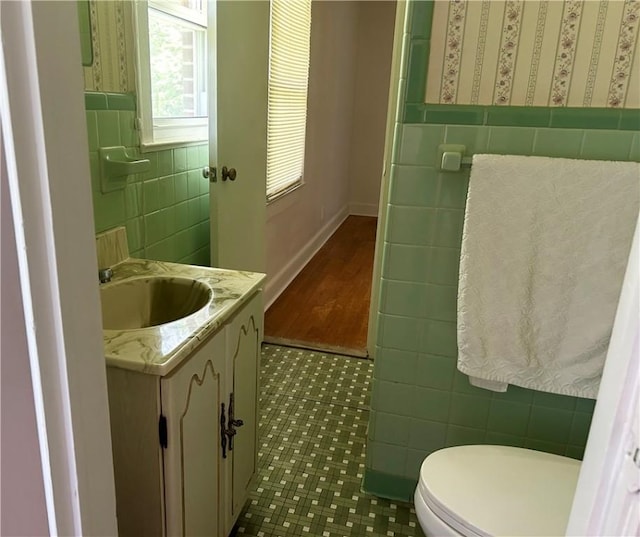 502 Cheyenne St, Anderson, SC 29626 - bathroom featuring tile walls, vanity, toilet, tile patterned flooring, and a wainscoted wall