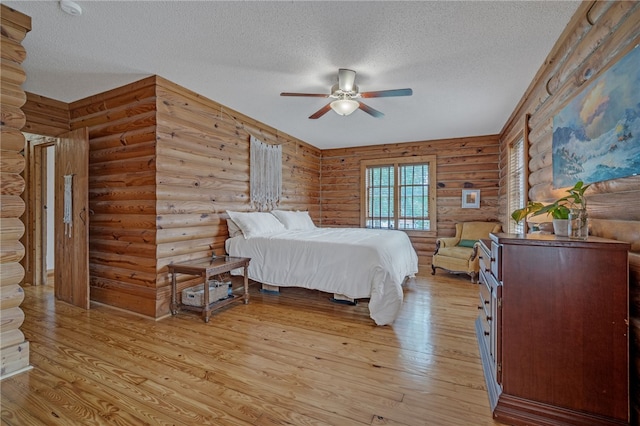 60 Lakeside Dr, Lyman, SC 29365 - bedroom featuring a textured ceiling, light wood-type flooring, log walls, and a ceiling fan