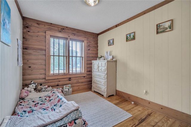 60 Lakeside Dr, Lyman, SC 29365 - bedroom featuring log walls, a textured ceiling, and light wood-style flooring