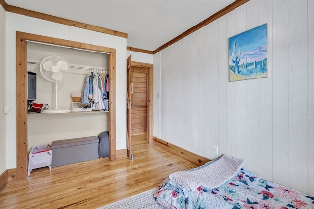 60 Lakeside Dr, Lyman, SC 29365 - bedroom featuring wood finished floors, crown molding, a closet, baseboards, and wooden walls