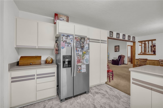 211 Jana Dr, Walhalla, SC 29691 - kitchen featuring stainless steel fridge, white cabinetry, light countertops, and open floor plan