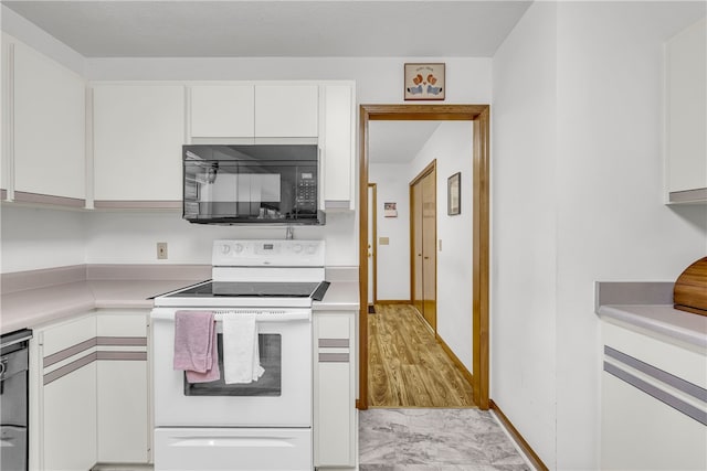 211 Jana Dr, Walhalla, SC 29691 - kitchen featuring black microwave, white range with electric stovetop, white cabinets, light countertops, and light marble finish flooring
