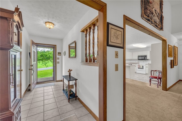 211 Jana Dr, Walhalla, SC 29691 - foyer entrance featuring a textured ceiling, baseboards, and light tile patterned flooring