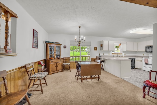 211 Jana Dr, Walhalla, SC 29691 - dining space featuring light carpet, a chandelier, and a textured ceiling