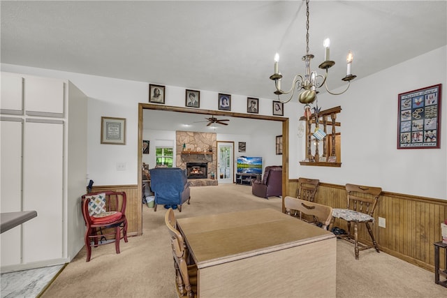 211 Jana Dr, Walhalla, SC 29691 - dining room featuring light colored carpet, wainscoting, a fireplace, a ceiling fan, and a chandelier