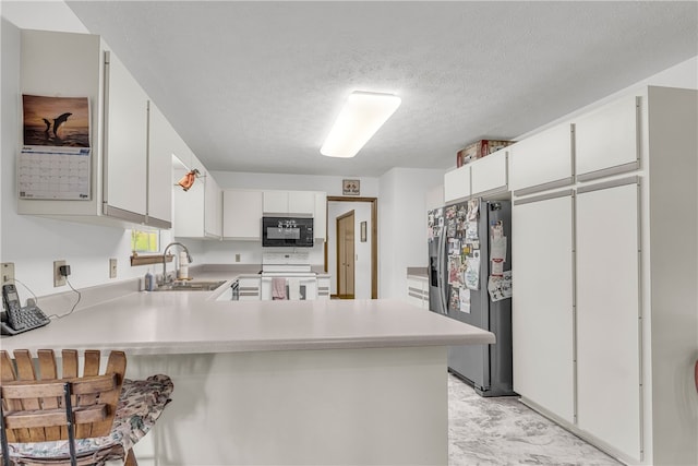 211 Jana Dr, Walhalla, SC 29691 - kitchen with black microwave, stainless steel refrigerator with ice dispenser, white electric range, a sink, and a peninsula