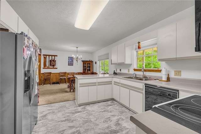 211 Jana Dr, Walhalla, SC 29691 - kitchen with stainless steel fridge, a sink, black dishwasher, a peninsula, and a chandelier