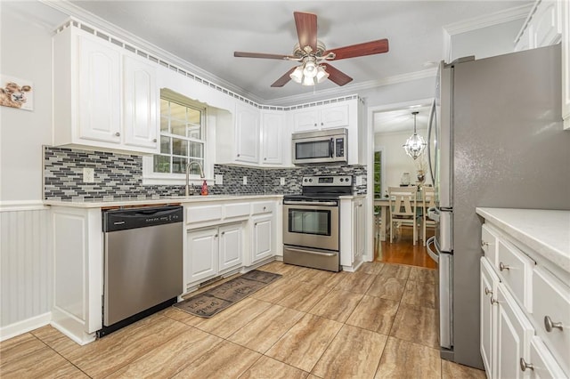 108 Ascot Ct, Easley, SC 29642 - kitchen featuring stainless steel appliances, decorative backsplash, white cabinetry, a sink, and a ceiling fan