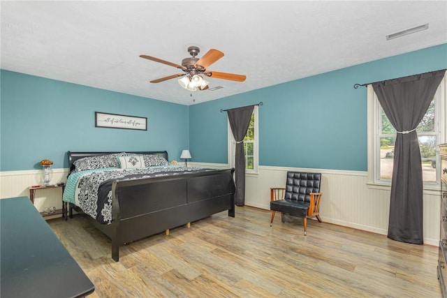 108 Ascot Ct, Easley, SC 29642 - bedroom featuring wainscoting, wood finished floors, multiple windows, and ceiling fan