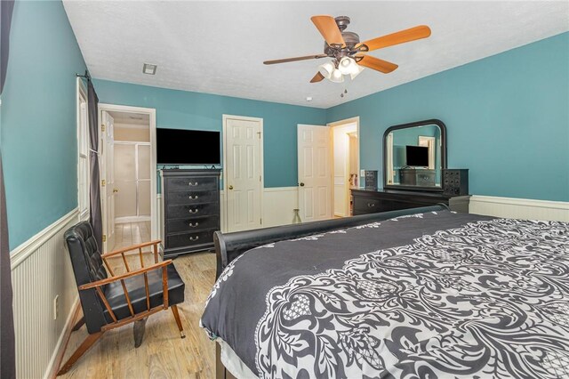 108 Ascot Ct, Easley, SC 29642 - bedroom with wood finished floors, a wainscoted wall, and a ceiling fan