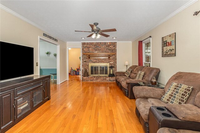 108 Ascot Ct, Easley, SC 29642 - living area with a ceiling fan, light wood-style flooring, ornamental molding, a fireplace, and baseboards
