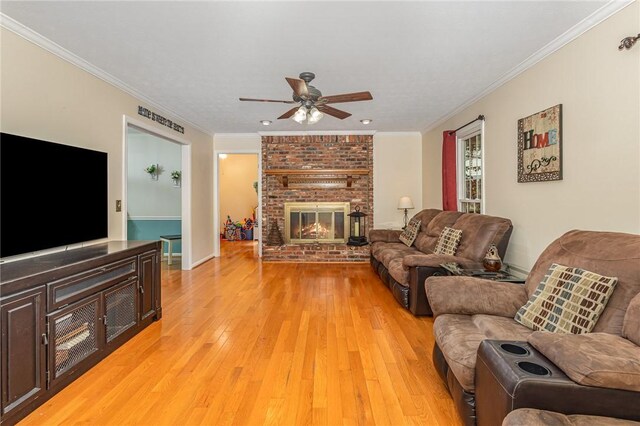 108 Ascot Ct, Easley, SC 29642 - living area featuring ceiling fan, light wood-style floors, a brick fireplace, crown molding, and baseboards
