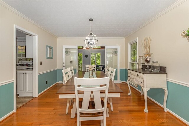 108 Ascot Ct, Easley, SC 29642 - dining space featuring a chandelier, crown molding, wood finished floors, and baseboards