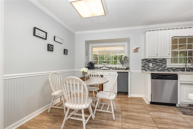 108 Ascot Ct, Easley, SC 29642 - kitchen with stainless steel dishwasher, crown molding, white cabinetry, light countertops, and backsplash