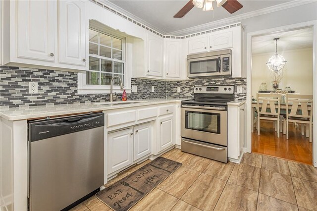 108 Ascot Ct, Easley, SC 29642 - kitchen with appliances with stainless steel finishes, a sink, light countertops, crown molding, and white cabinets