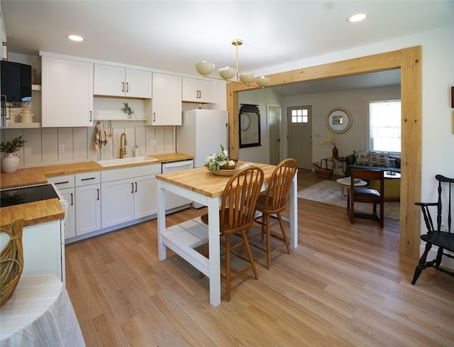 202 S Broad St, Westminster, SC 29693 - kitchen with wood counters, open shelves, white appliances, a sink, and light wood-style floors