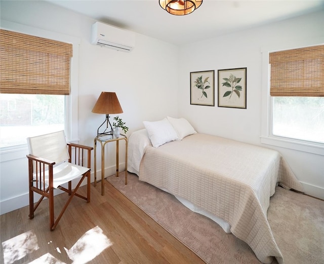 202 S Broad St, Westminster, SC 29693 - bedroom with a wall mounted air conditioner, multiple windows, and wood finished floors