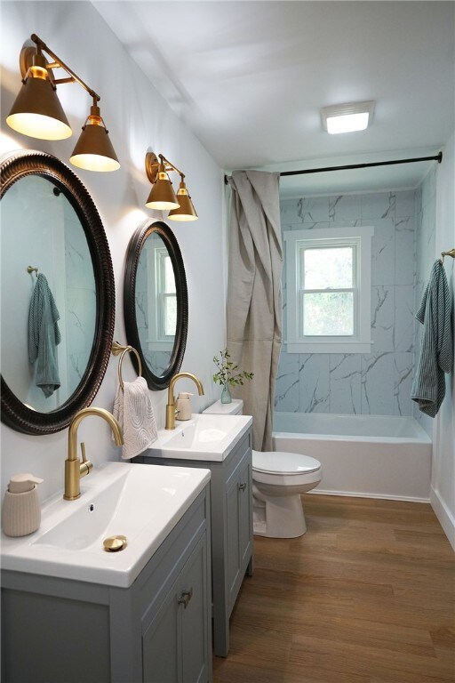 202 S Broad St, Westminster, SC 29693 - bathroom with wood finished floors, shower / bath combo with shower curtain, vanity, and toilet