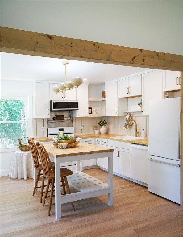 202 S Broad St, Westminster, SC 29693 - kitchen featuring white appliances, light countertops, open shelves, a sink, and light wood-type flooring