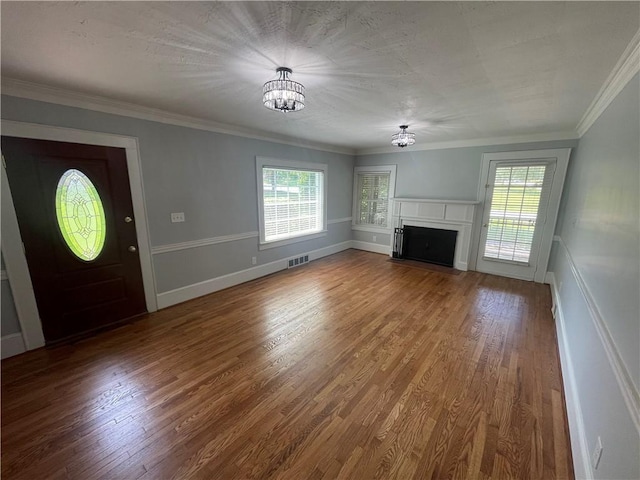 501 Seneca Dr, Seneca, SC 29678 - unfurnished living room featuring a chandelier, a fireplace with flush hearth, wood finished floors, ornamental molding, and wainscoting
