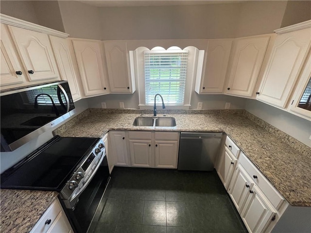 501 Seneca Dr, Seneca, SC 29678 - kitchen featuring stainless steel appliances, a sink, white cabinetry, light stone counters, and dark tile patterned flooring