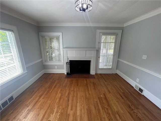 501 Seneca Dr, Seneca, SC 29678 - unfurnished living room featuring plenty of natural light, a fireplace with flush hearth, wood finished floors, and crown molding