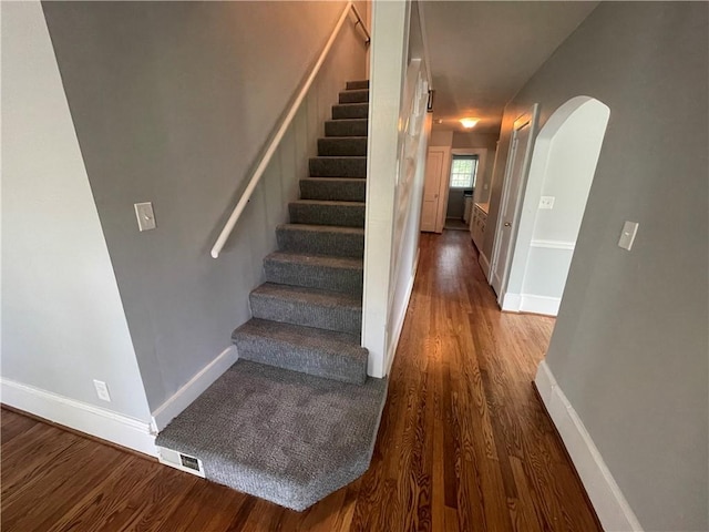 501 Seneca Dr, Seneca, SC 29678 - stairs with arched walkways, baseboards, and wood finished floors