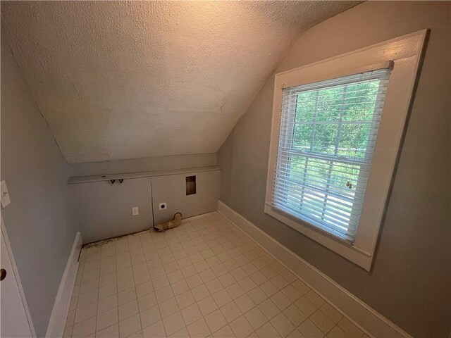 501 Seneca Dr, Seneca, SC 29678 - bonus room featuring a textured ceiling, lofted ceiling, and baseboards