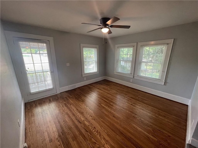 501 Seneca Dr, Seneca, SC 29678 - spare room featuring healthy amount of natural light, dark wood-style flooring, ceiling fan, and baseboards