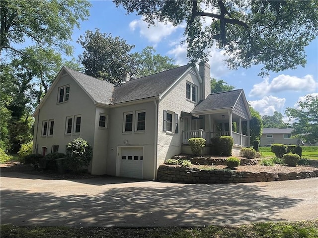 501 Seneca Dr, Seneca, SC 29678 - view of property exterior with an attached garage, roof with shingles, a chimney, and driveway