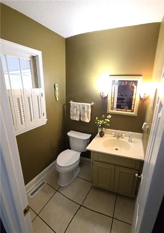 261 N Mcallister Rd, Liberty, SC 29657 - half bathroom featuring toilet, baseboards, vanity, tile patterned floors, and a textured ceiling
