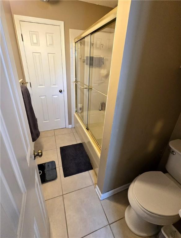 261 N Mcallister Rd, Liberty, SC 29657 - full bath with tile patterned floors, toilet, and bath / shower combo with glass door