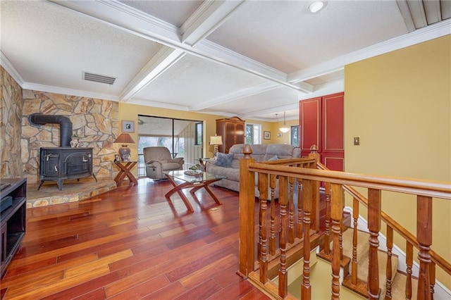 261 N Mcallister Rd, Liberty, SC 29657 - living room with a wood stove, wood finished floors, beamed ceiling, crown molding, and a textured ceiling