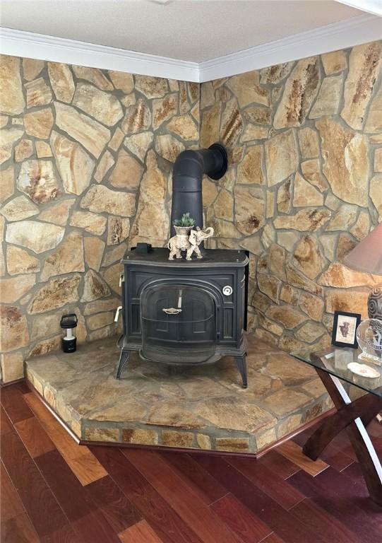 261 N Mcallister Rd, Liberty, SC 29657 - detailed view of a wood stove, crown molding, and wood finished floors