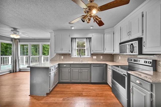 1208 Marett Rd, Pendleton, SC 29670 - kitchen with stainless steel appliances, ceiling fan, gray cabinetry, a sink, and a peninsula