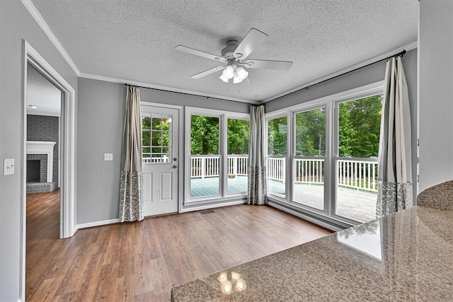 1208 Marett Rd, Pendleton, SC 29670 - unfurnished sunroom featuring wood finished floors, a textured ceiling, plenty of natural light, ornamental molding, and baseboards