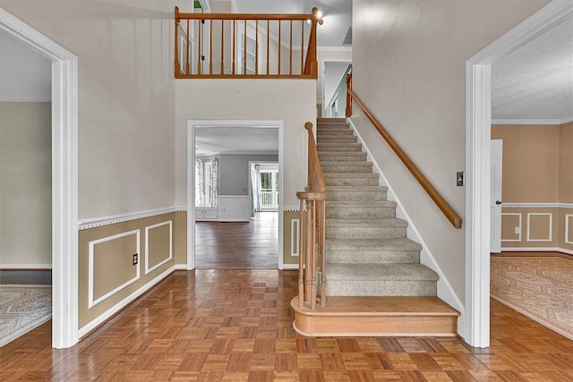 1208 Marett Rd, Pendleton, SC 29670 - staircase with a decorative wall, wainscoting, and crown molding