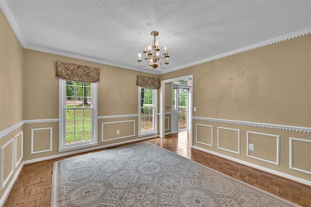 1208 Marett Rd, Pendleton, SC 29670 - spare room with a chandelier, a textured ceiling, a decorative wall, and wainscoting