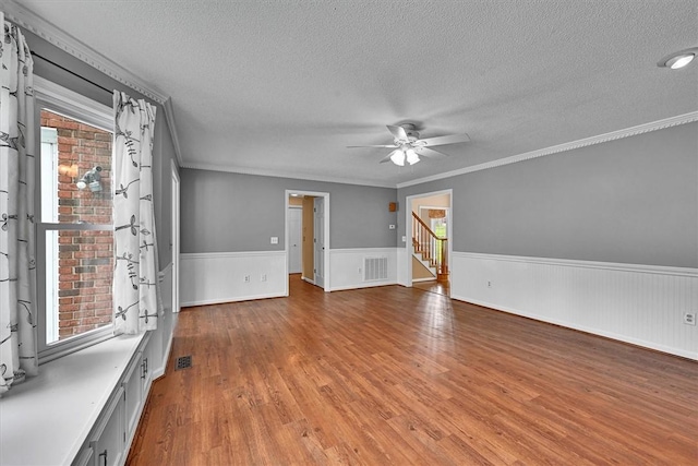 1208 Marett Rd, Pendleton, SC 29670 - unfurnished room with a textured ceiling, a ceiling fan, wainscoting, crown molding, and wood finished floors