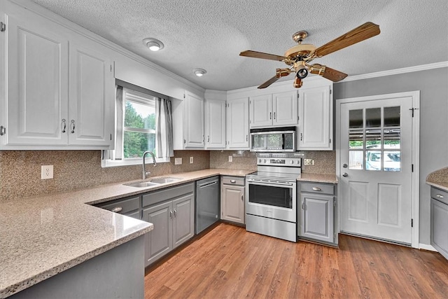 1208 Marett Rd, Pendleton, SC 29670 - kitchen featuring stainless steel appliances, gray cabinetry, a sink, light wood-type flooring, and crown molding