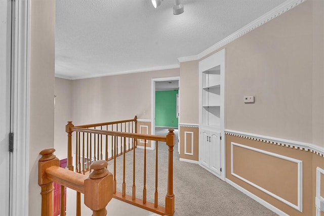 1208 Marett Rd, Pendleton, SC 29670 - hall featuring an upstairs landing, a textured ceiling, ornamental molding, carpet, and built in shelves