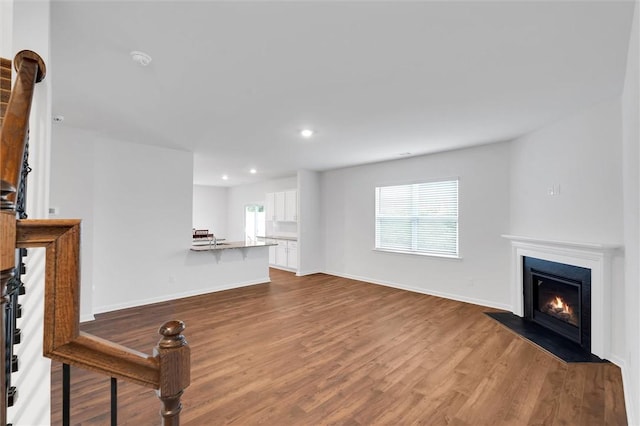 204 Lily Pond Pl, Easley, SC 29642 - unfurnished living room featuring dark wood-style floors, a fireplace with flush hearth, baseboards, and recessed lighting