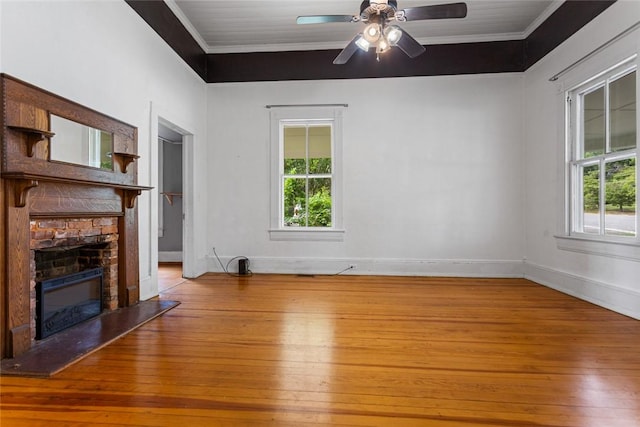 300 S Fairplay St, Seneca, SC 29678 - unfurnished living room featuring crown molding, light wood-type flooring, healthy amount of natural light, a stone fireplace, and baseboards