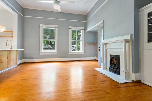 300 S Fairplay St, Seneca, SC 29678 - unfurnished living room featuring crown molding, wood finished floors, ceiling fan, a high end fireplace, and baseboards