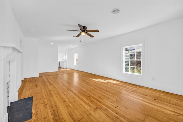 731 E Main St, Seneca, SC 29678 - unfurnished living room with ceiling fan, plenty of natural light, light wood-style floors, and baseboards