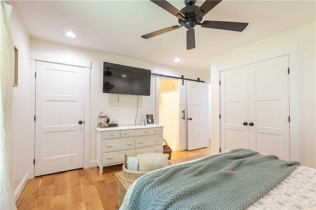 226 Edgewood Dr, Seneca, SC 29678 - bedroom with a barn door, light wood-style floors, recessed lighting, ceiling fan, and baseboards