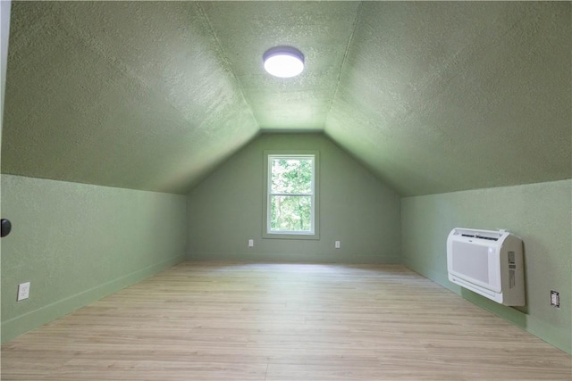 226 Edgewood Dr, Seneca, SC 29678 - additional living space with a textured ceiling, light wood finished floors, heating unit, lofted ceiling, and baseboards