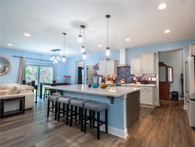 1019 Glen Rd, Seneca, SC 29672 - kitchen featuring wall chimney range hood, freestanding refrigerator, open floor plan, decorative backsplash, and dark wood finished floors