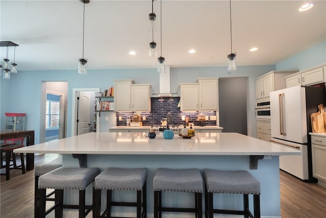 1019 Glen Rd, Seneca, SC 29672 - kitchen with freestanding refrigerator, tasteful backsplash, light countertops, a breakfast bar area, and recessed lighting